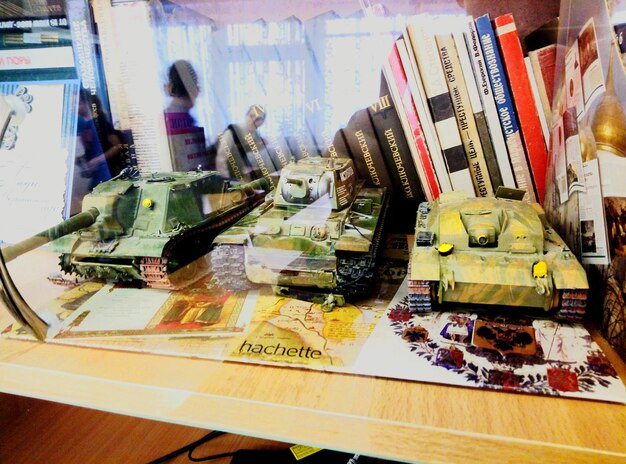 A split image showing a military tank on one side and a classroom on the other, symbolizing the trade-offs between military spending and education.
