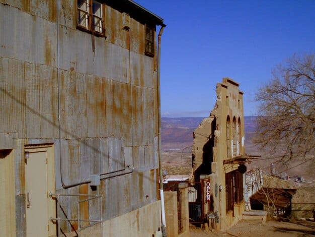 A photograph of abandoned and dilapidated buildings in a Middle Eastern city, symbolizing the failure of diplomatic efforts to prevent or resolve conflict in the region.