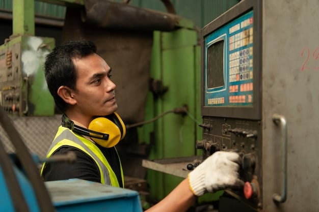 A close-up shot of a worker in a US factory operating a high-tech machine. The worker is wearing safety glasses and appears focused and skilled. The machine is clean and modern, highlighting technological advancement in US manufacturing.